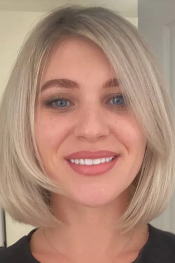 Krátký blond bob s ofinou sčesanou do stran — dámský střih Newtone Brno